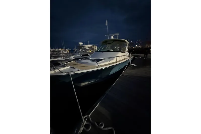 Slide: The Image of 2019 Grady-White Express 330 boat docked at marina, front view. - 2