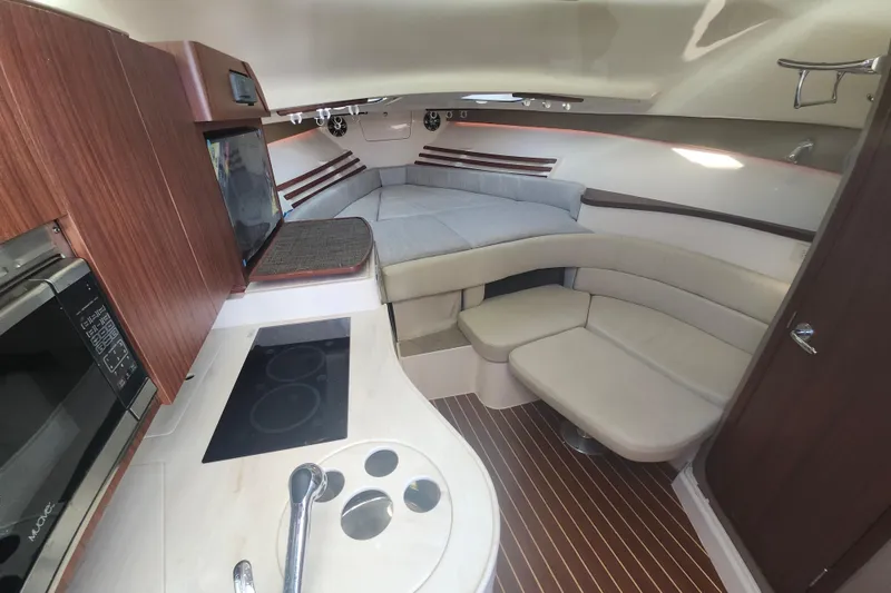 Slide: The Image of 2019 Grady-White Express 330 cabin interior with kitchen, seating, and sleeping area. - 22