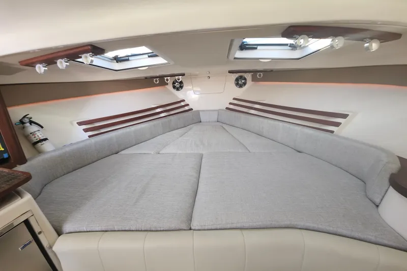 Slide: The Image of 2019 Grady-White Express 330 cabin interior with spacious seating and modern design. - 23