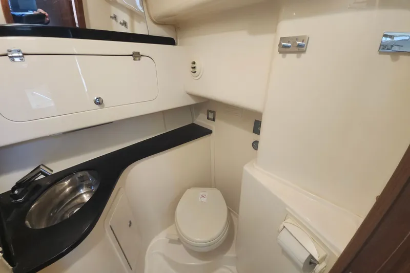 Slide: The Image of 2019 Grady-White Express 330 boat bathroom with sink, toilet, and storage. - 27