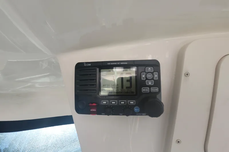 Slide: The Image of VHF marine radio on 2019 Grady-White Express 330 boat dashboard. - 32