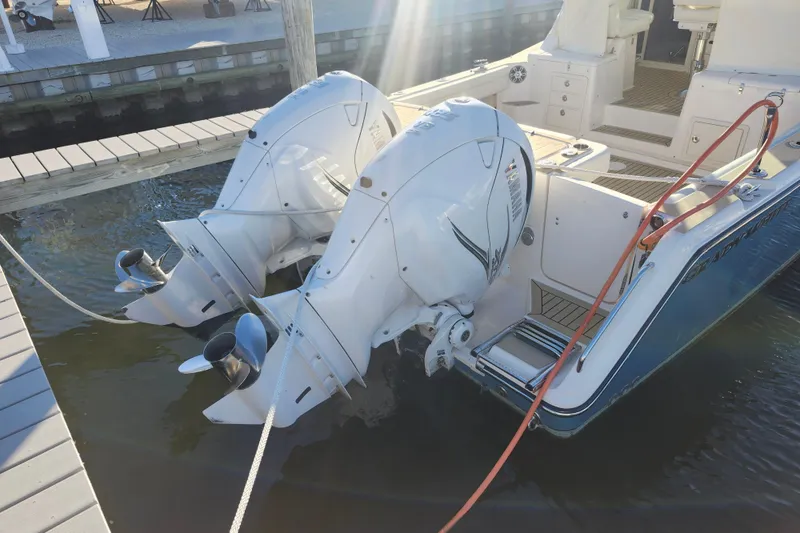 Slide: The Image of 2019 Grady-White Express 330 with dual outboard engines docked at marina. - 35