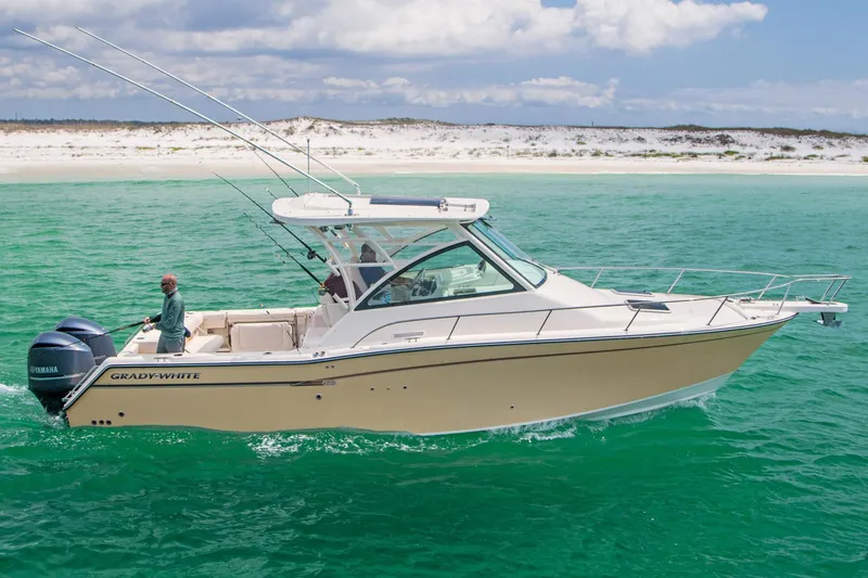 Slide: The Image of 2019 Grady-White Express 330 boat docked in marina, blue hull, sunny day. - 4