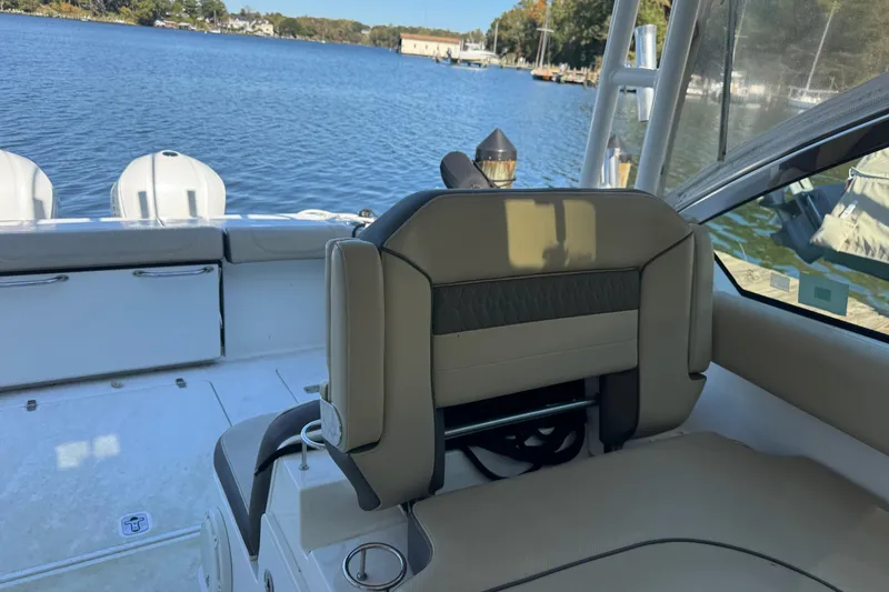 Slide: The Image of 2019 Pursuit DC 325 Dual Console boat interior with lake view. - 10