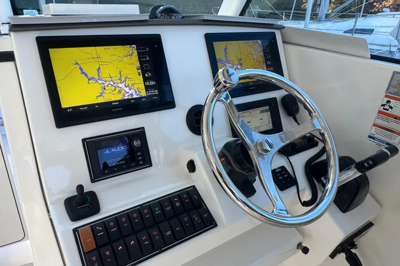Slide: The Image of 2019 Pursuit DC 325 Dual Console dashboard with navigation screens and controls. - 13