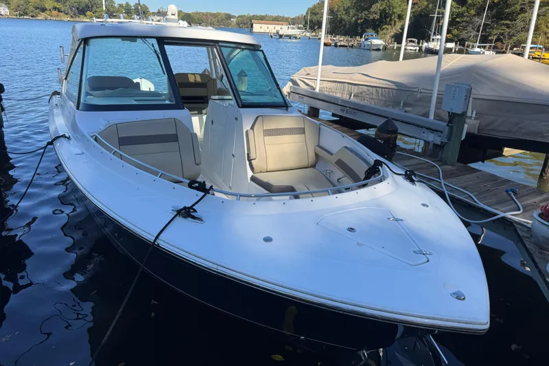 Slide: The Image of 2019 Pursuit DC 325 Dual Console boat docked on a serene lake. - 21