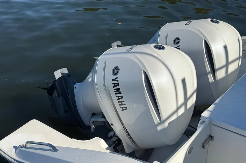 Slide: The Image of 2019 Pursuit DC 325 Dual Console with twin Yamaha outboard engines on water. - 22