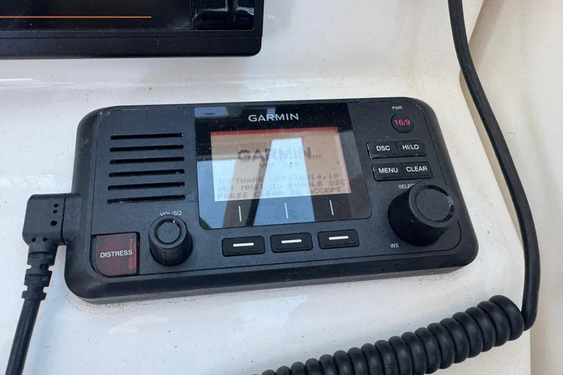 Slide: The Image of Garmin marine radio on 2019 Pursuit DC 325 Dual Console boat dashboard. - 29