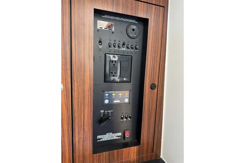 Slide: The Image of Control panel of 2019 Pursuit DC 325 Dual Console boat, featuring switches and outlets. - 36