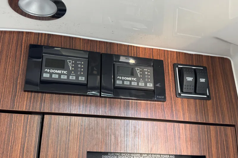 Slide: The Image of Control panel on 2019 Pursuit DC 325 Dual Console boat with Dometic systems and light switches. - 37