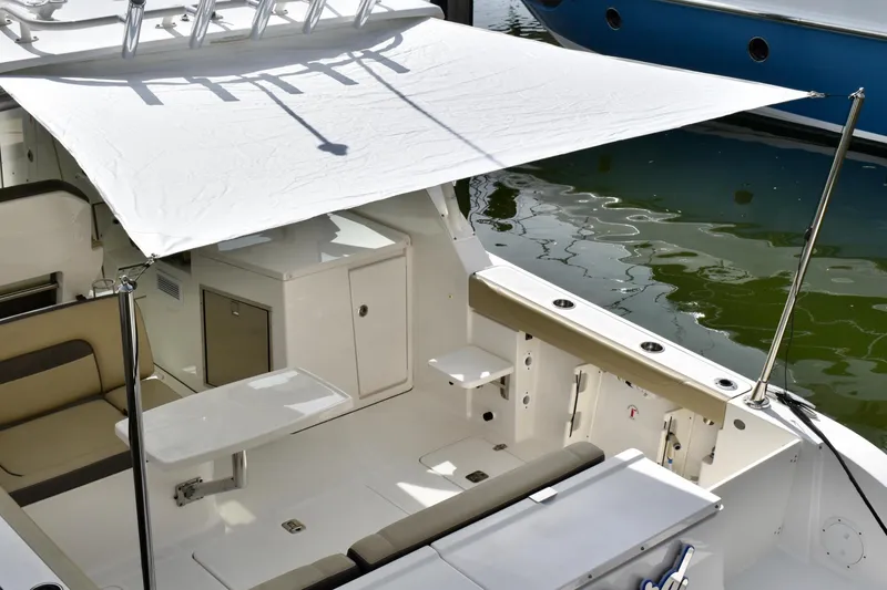 Slide: The Image of 2019 Pursuit DC 325 Dual Console boat with sunshade and seating area. - 4