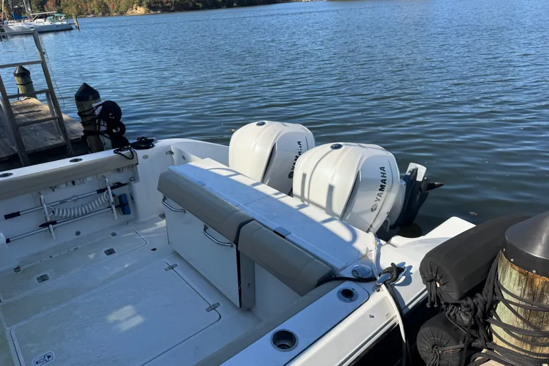 Slide: The Image of 2019 Pursuit DC 325 Dual Console boat with Yamaha engines docked by the water. - 6