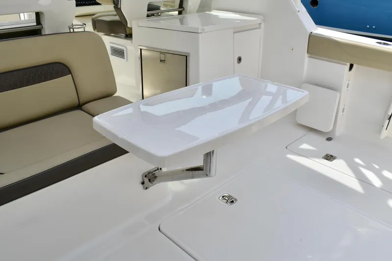 Slide: The Image of 2019 Pursuit DC 325 Dual Console interior with seating and foldable table. - 8
