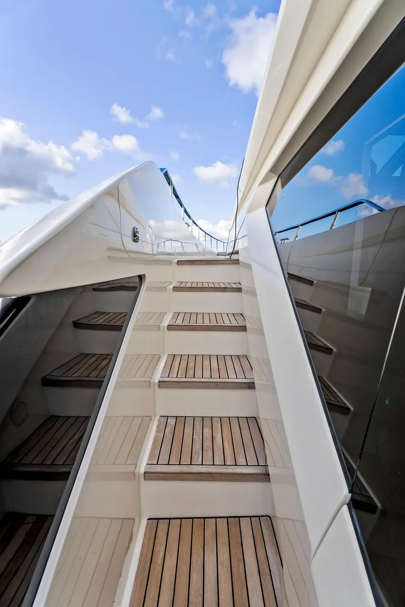 Slide: The Image of Staircase on 2020 Ferretti Yachts 920, leading to upper deck under blue sky. - 11