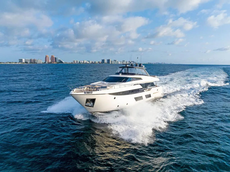 Slide: The Image of 2020 Ferretti Yachts 920 cruising on open water with city skyline in background. - 5