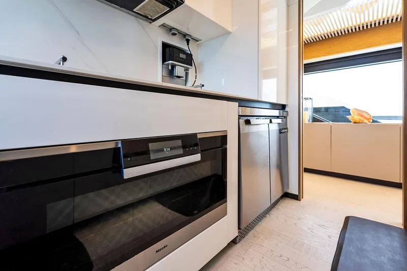 Slide: The Image of Modern kitchen interior on 2020 Ferretti Yachts 920, featuring sleek appliances and ocean view. - 34