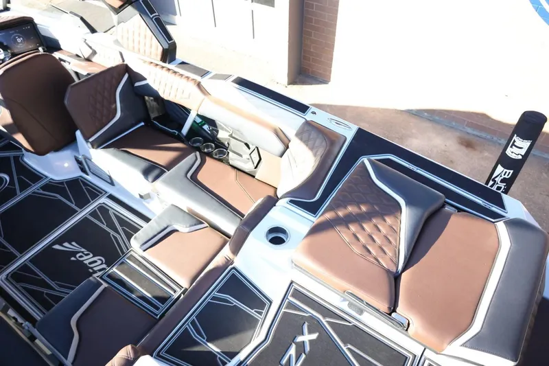 Slide: The Image of 2026 Tigé 24RZX boat interior with brown leather seats and modern design. - 12