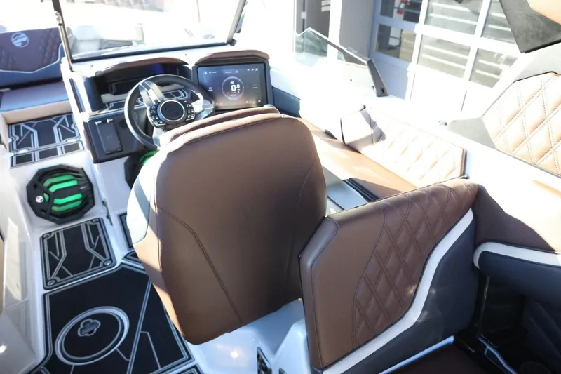 Slide: The Image of 2026 Tigé 24RZX boat interior with brown leather seats and modern dashboard. - 14
