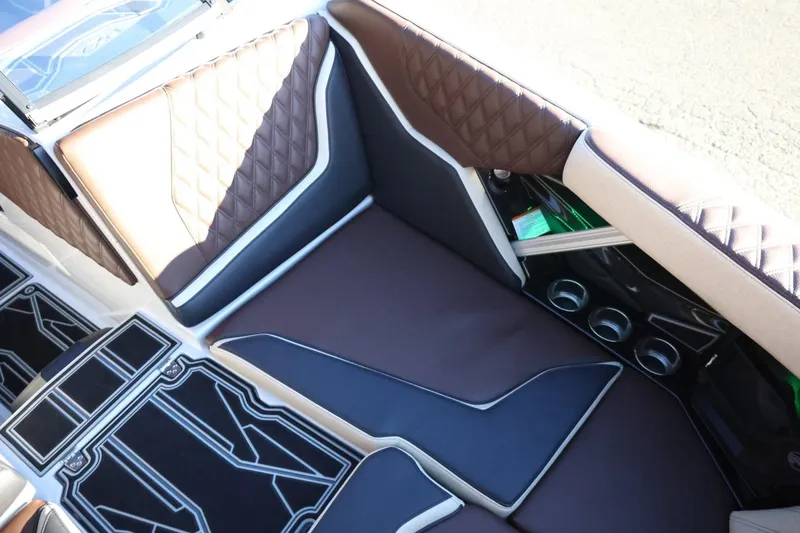 Slide: The Image of Luxurious interior of 2026 Tigé 24RZX boat with quilted brown seating. - 19