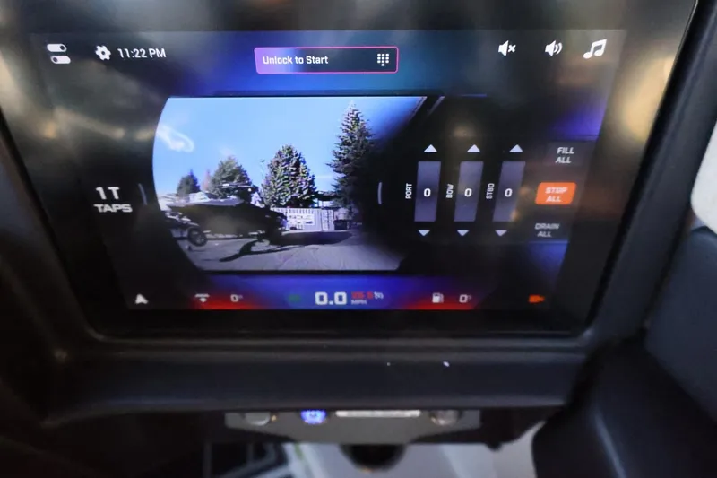 Slide: The Image of Touchscreen display of 2026 Tigé 24RZX boat showing rearview camera and control settings. - 28