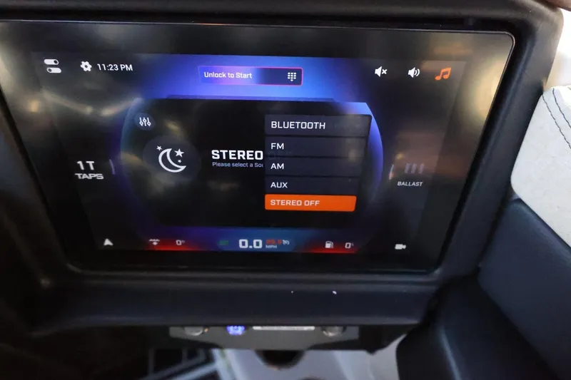 Slide: The Image of Touchscreen interface of 2026 Tigé 24RZX boat, displaying stereo and Bluetooth options. - 29