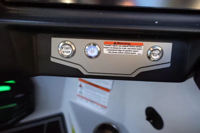 Slide: The Image of Control panel of 2026 Tigé 24RZX boat with start/stop button and warning label. - 34