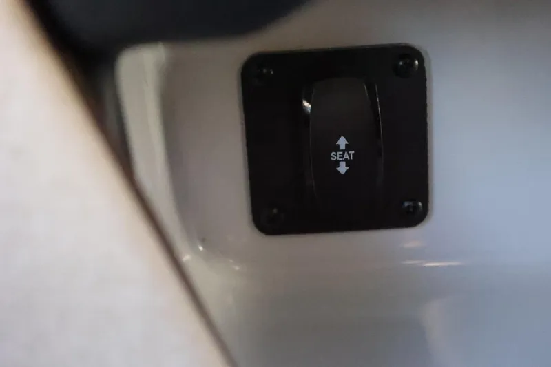 Slide: The Image of 2026 Tigé 24RZX seat adjustment switch, black panel with up and down arrows. - 36