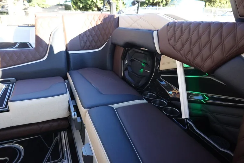 Slide: The Image of Luxurious interior of 2026 Tigé 24RZX boat with brown and black seating. - 38