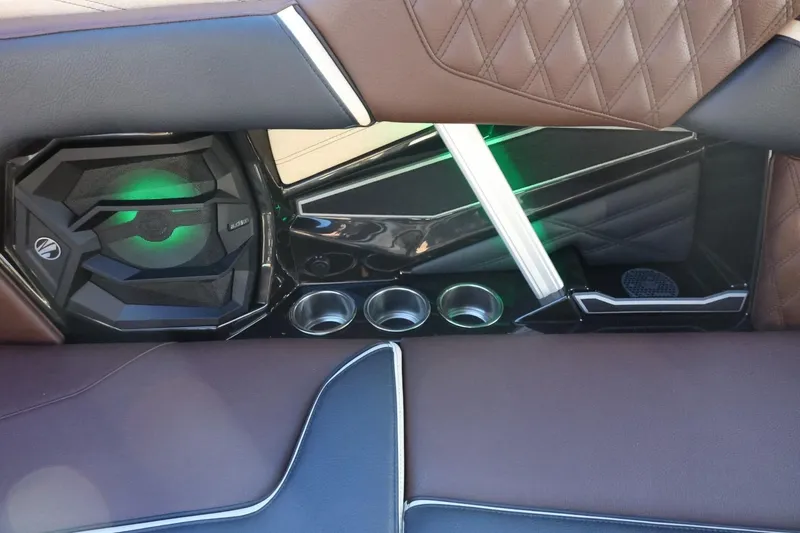 Slide: The Image of 2026 Tigé 24RZX interior with premium speaker, cup holders, and quilted leather seating. - 39