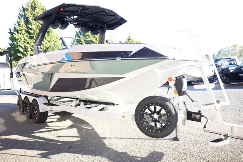Slide: The Image of 2026 Tigé 24RZX boat on trailer, sleek design, parked outdoors. - 4