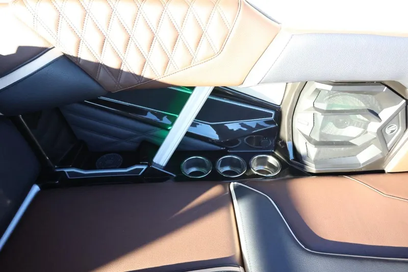 Slide: The Image of 2026 Tigé 24RZX interior with brown leather seats, cup holders, and speaker system. - 40
