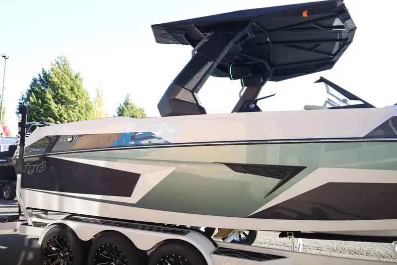 Slide: The Image of 2026 Tigé 24RZX boat with sleek design and modern features, parked on a trailer. - 5