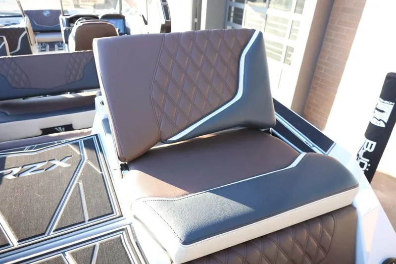 Slide: The Image of 2026 Tigé 24RZX boat interior with stylish brown and black seating. - 54