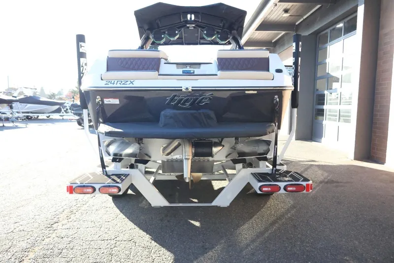 Slide: The Image of 2026 Tigé 24RZX boat rear view, showcasing sleek design and modern features. - 7