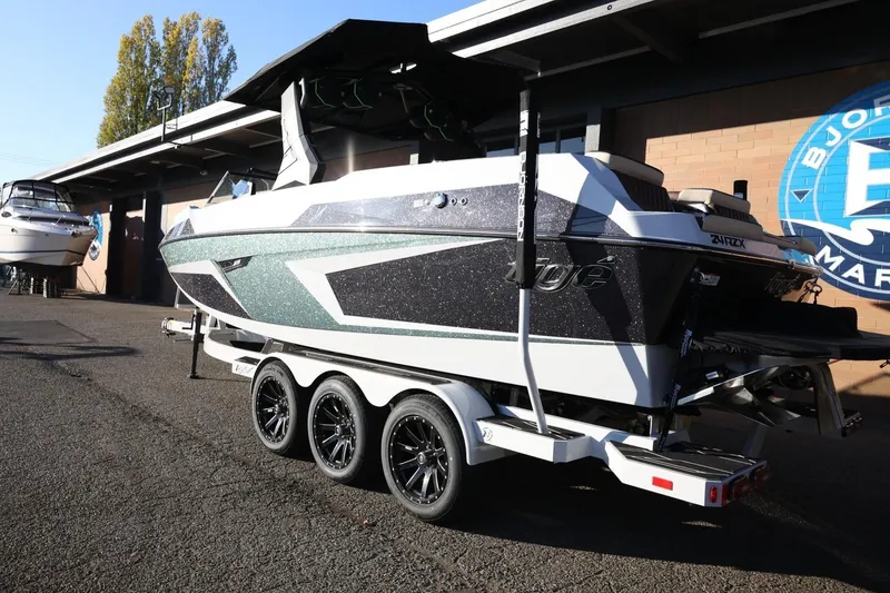 Slide: The Image of 2026 Tigé 24RZX boat on a trailer at a marina, side view. - 8