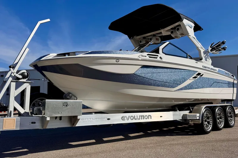 Slide: The Image of 2025 Centurion Ri245 boat on trailer, featuring sleek design and modern features. - 12