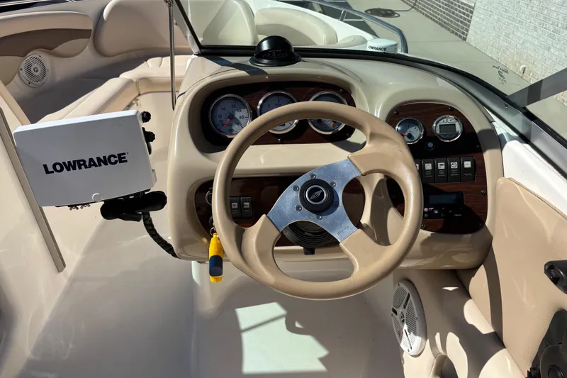 Slide: The Image of 2007 Chaparral 210 SSi boat dashboard with Lowrance navigation system and beige steering wheel. - 10