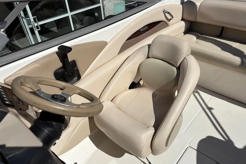 Slide: The Image of 2007 Chaparral 210 SSi boat interior with beige seating and steering wheel. - 11