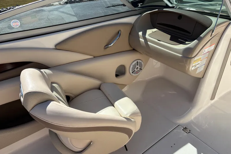Slide: The Image of Interior of 2007 Chaparral 210 SSi boat, featuring beige seating and dashboard. - 12