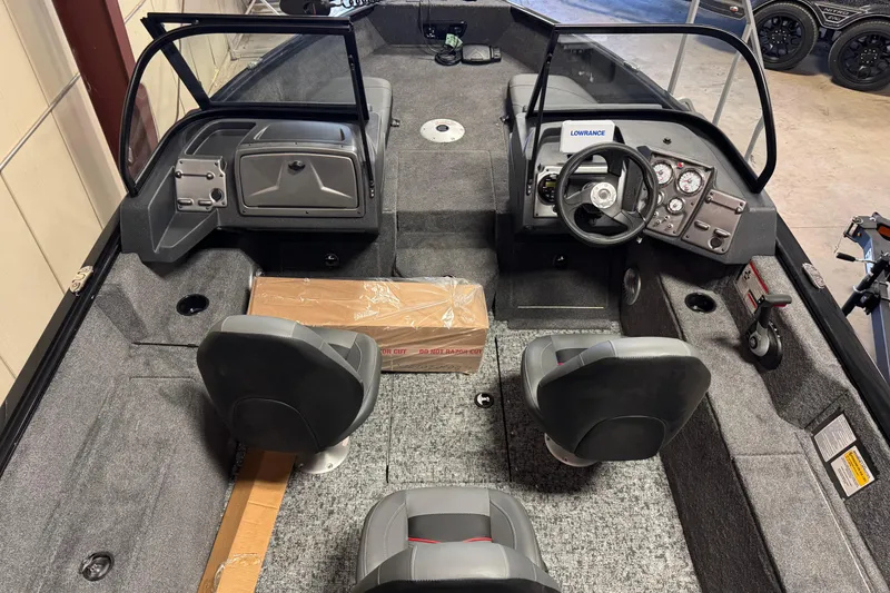 Slide: The Image of 2026 Tracker Pro Guide V-175 Combo boat interior with steering console and seating. - 12