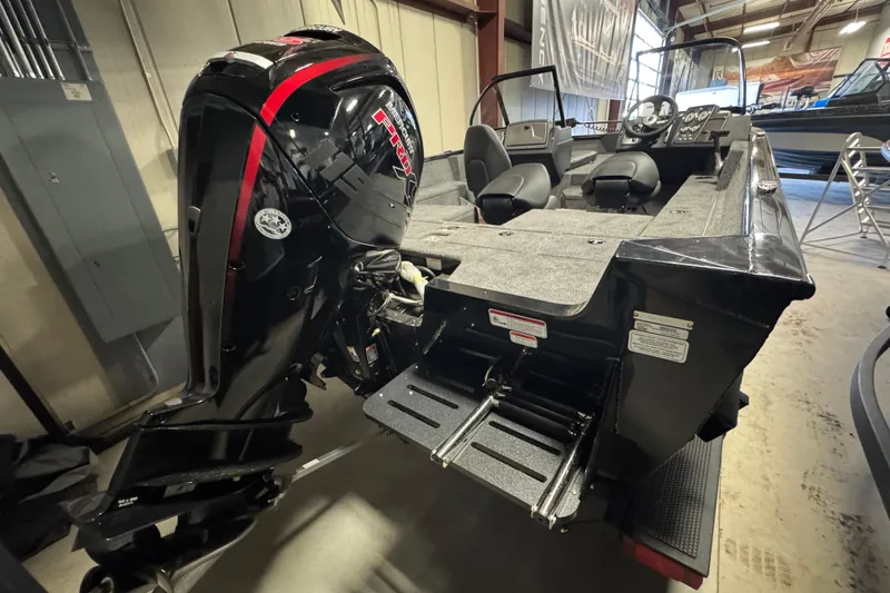 Slide: The Image of 2026 Tracker Pro Guide V-175 Combo boat with powerful outboard motor in showroom. - 4