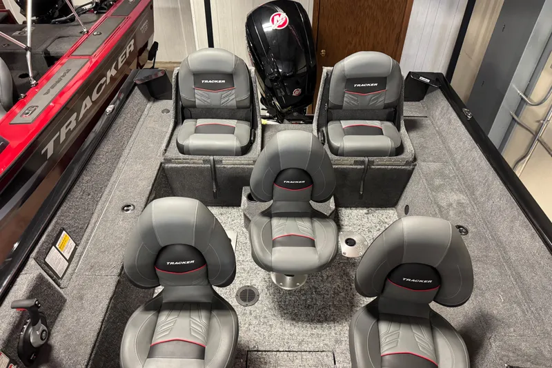 Slide: The Image of 2026 Tracker Pro Guide V-175 Combo boat interior with five gray seats and motor. - 6