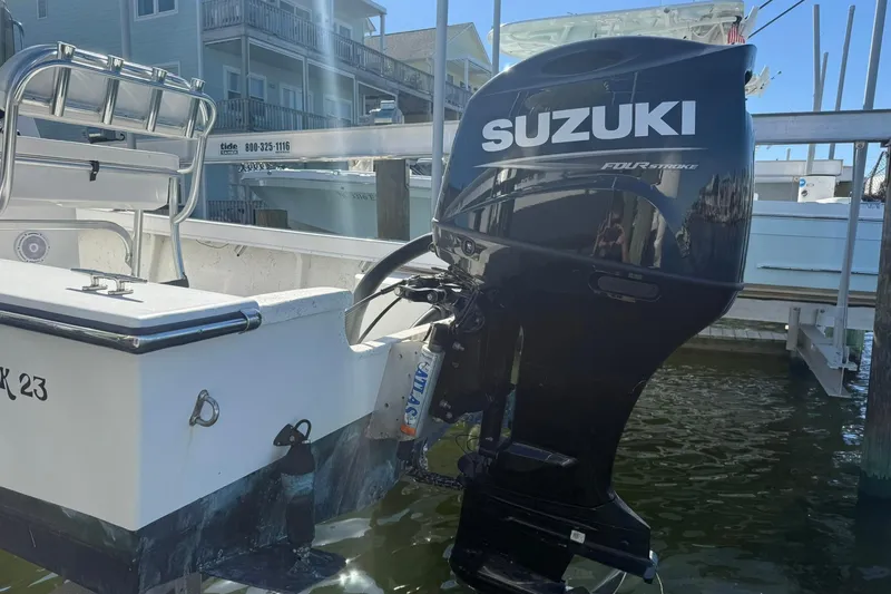 Slide: The Image of 2023 C-Hawk 23 Center Console with Suzuki outboard motor docked in marina. - 10