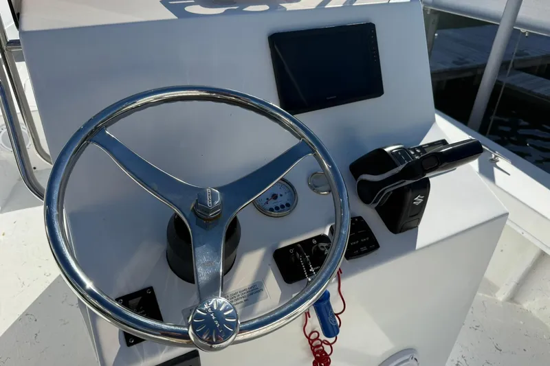 Slide: The Image of Steering console of 2023 C-Hawk 23 Center Console boat with controls and display. - 12