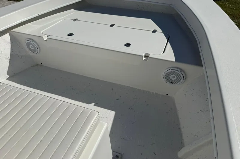 Slide: The Image of 2023 C-Hawk 23 Center Console boat interior with speakers and storage compartment. - 18
