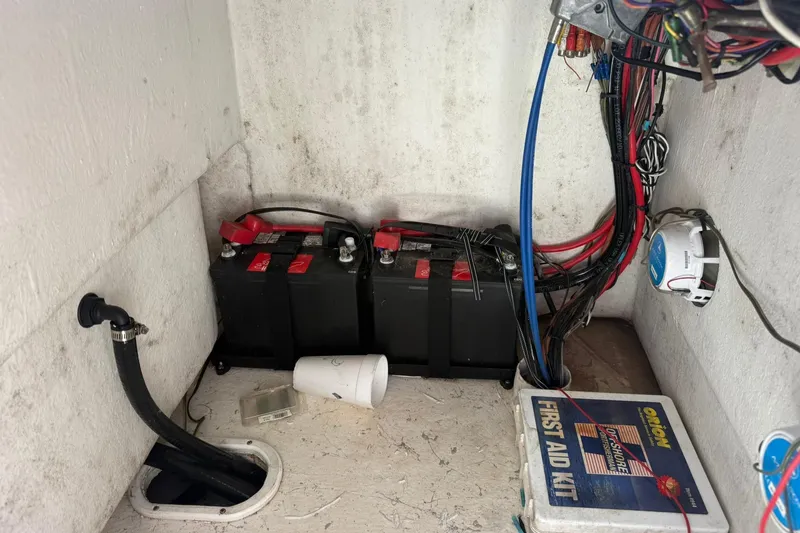 Slide: The Image of Interior of 2023 C-Hawk 23 Center Console showing batteries, wiring, and first aid kit. - 19