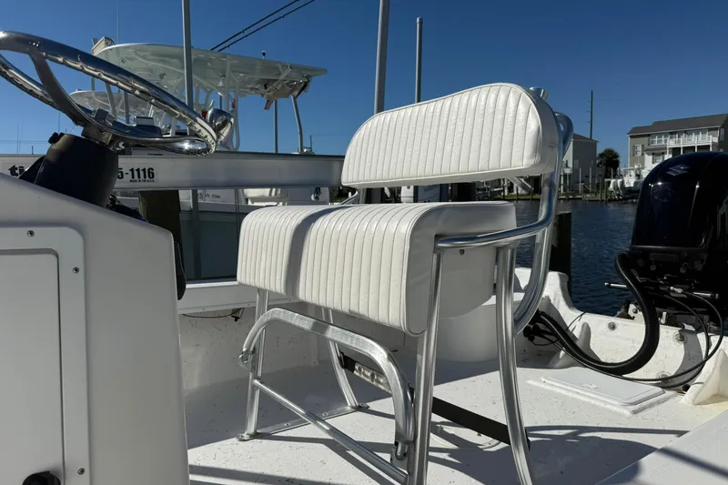 Slide: The Image of 2023 C-Hawk 23 Center Console boat with white seating and steering wheel. - 5