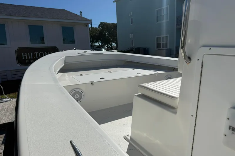 Slide: The Image of 2023 C-Hawk 23 Center Console boat docked near Hilton's building. - 7