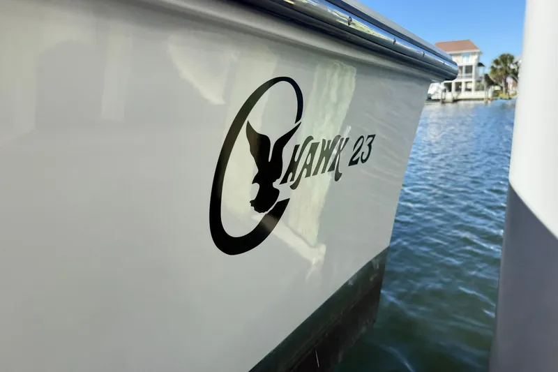 Slide: The Image of 2023 C-Hawk 23 Center Console boat on water, showcasing logo and sleek design. - 9