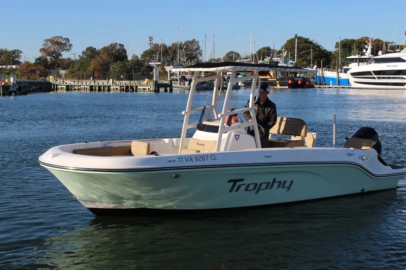 The Image of 2024 Bayliner CC22 Trophy boat cruising on a calm waterway. - 0